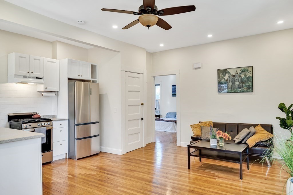 12 Rindge Avenue, Unit 2 Cambridge, MA 02140 - Photo 8 of 25 a kitchen with stainless steel appliances a refrigerator and a stove top oven