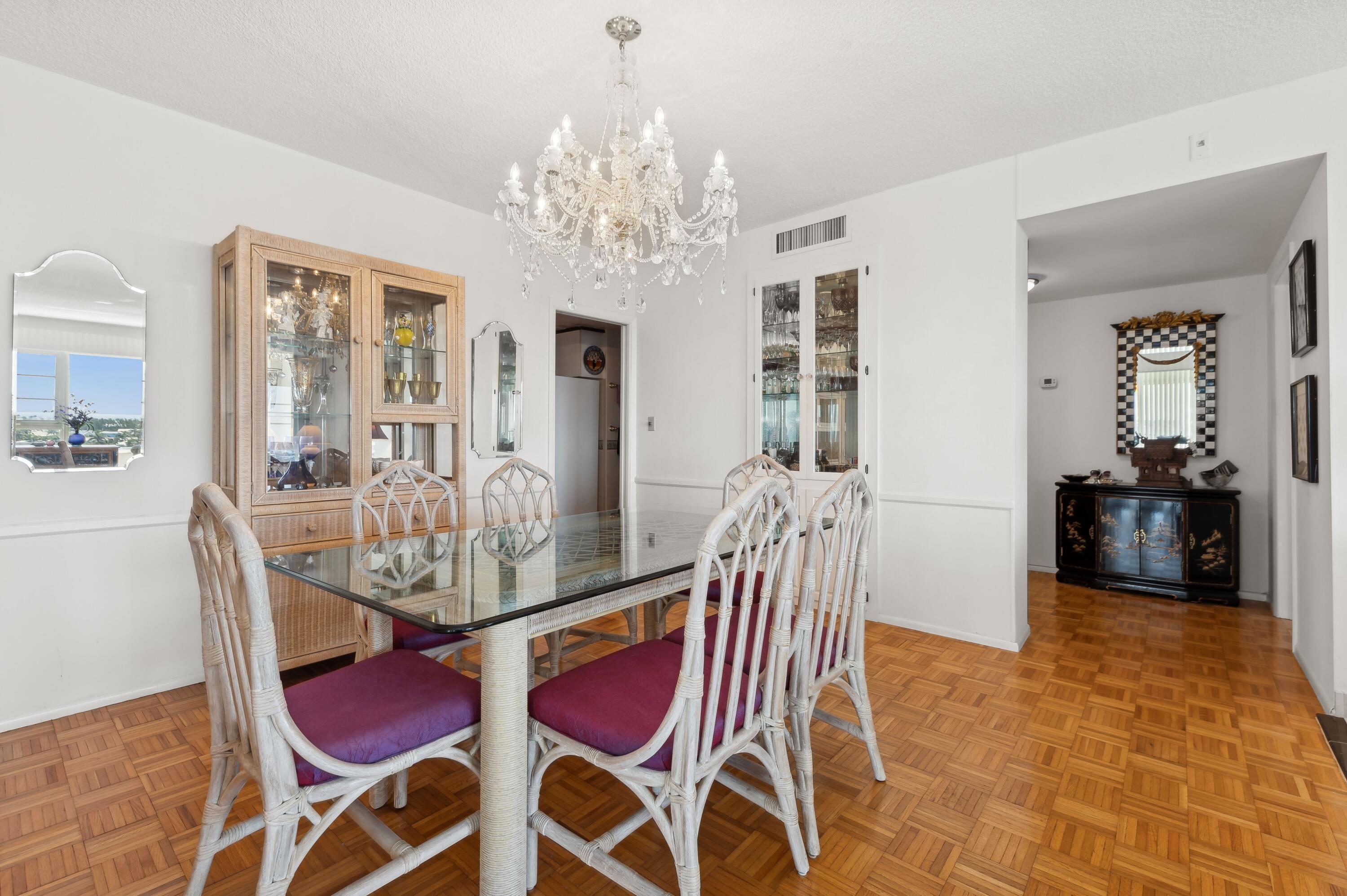 50 E Road, Unit 11F Delray Beach, FL 33483 - Photo 13 of 31 a view of a dining room with furniture and chandelier
