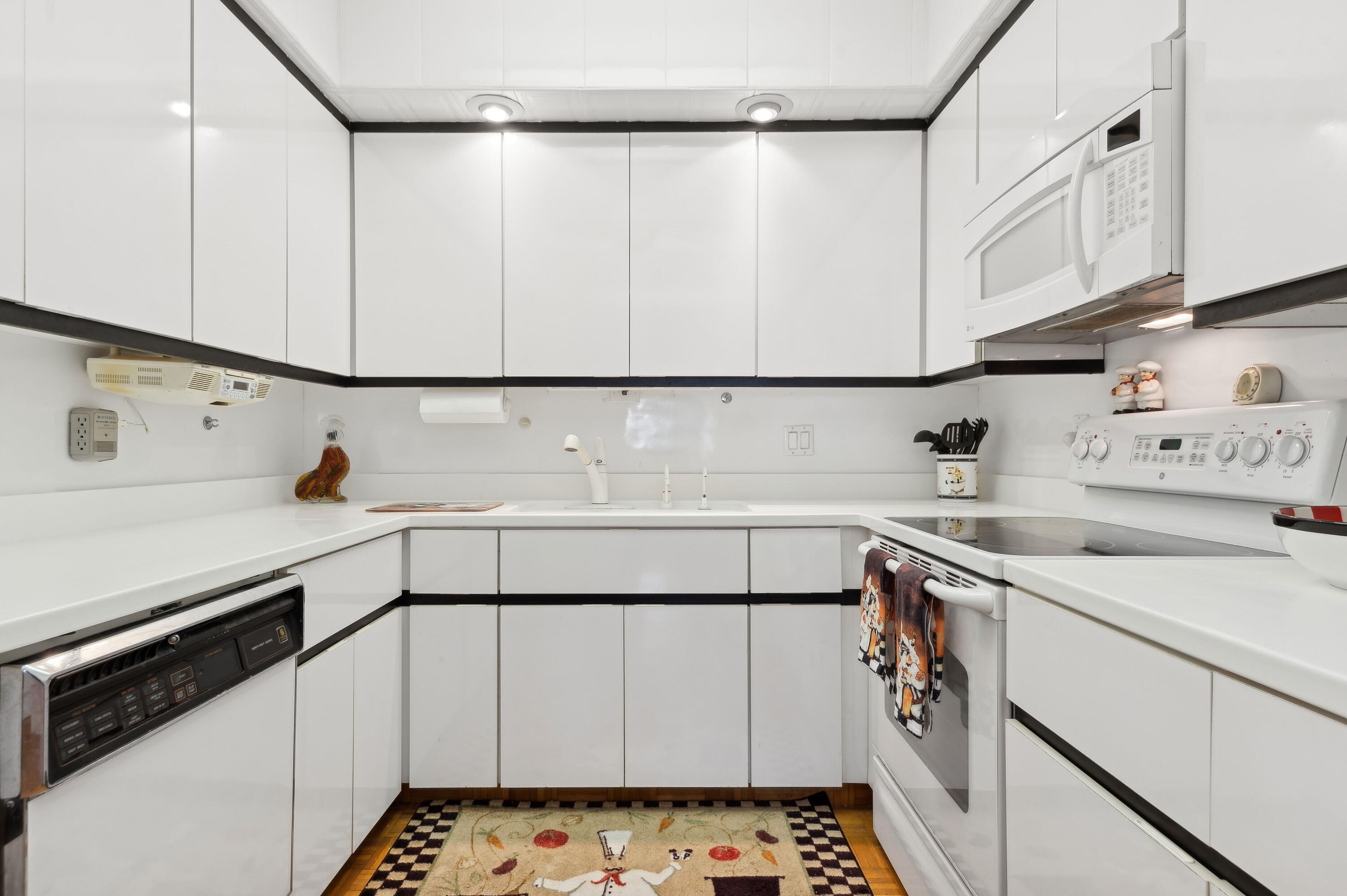50 E Road, Unit 11F Delray Beach, FL 33483 - Photo 15 of 31 a utility room with stainless steel appliances cabinets and a sink