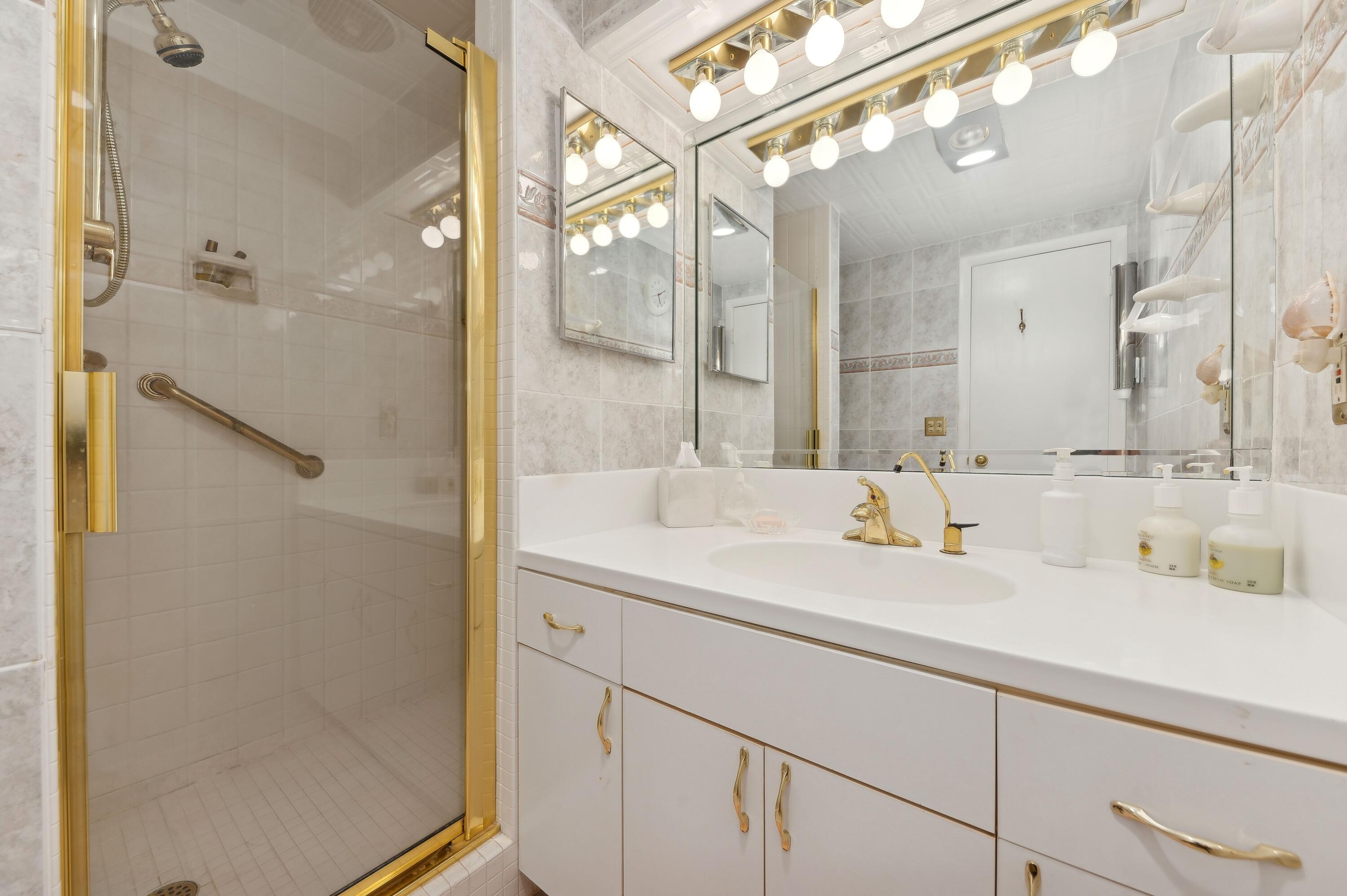 50 E Road, Unit 11F Delray Beach, FL 33483 - Photo 22 of 31 a bathroom with a sink and a mirror