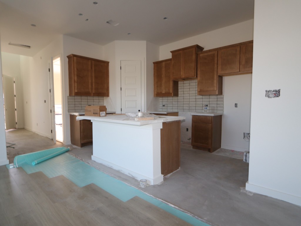 136 Bishop Wood Road Dripping Springs, TX 78620 - Photo 3 of 14 a kitchen with stainless steel appliances granite countertop a sink stove and refrigerator