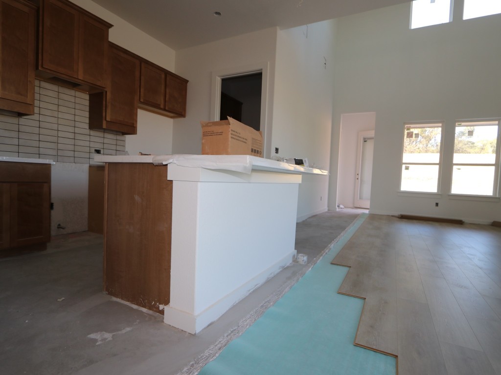 136 Bishop Wood Road Dripping Springs, TX 78620 - Photo 4 of 14 a view of a kitchen with a sink cabinets and wooden floor