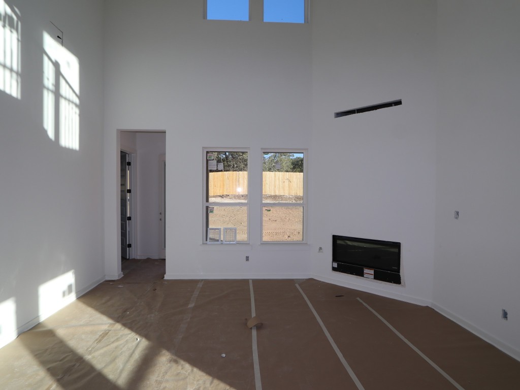 136 Bishop Wood Road Dripping Springs, TX 78620 - Photo 5 of 14 a living room with a couch and a flat screen tv