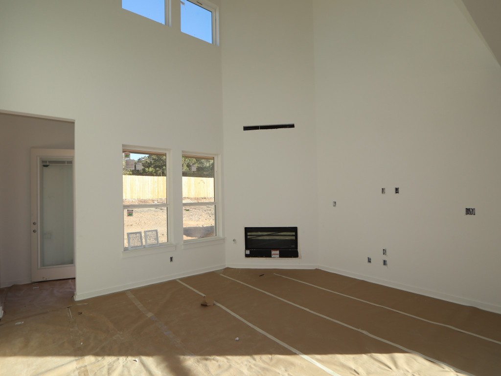 136 Bishop Wood Road Dripping Springs, TX 78620 - Photo 6 of 14 a view of empty room with wooden floor and fan