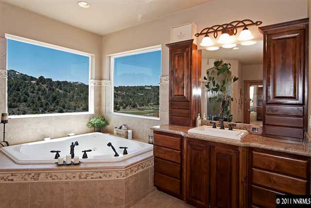 4840 Livery Road Reno, NV 89521 - Photo 8 of 12 a bath tub sitting in a bathroom next to a window