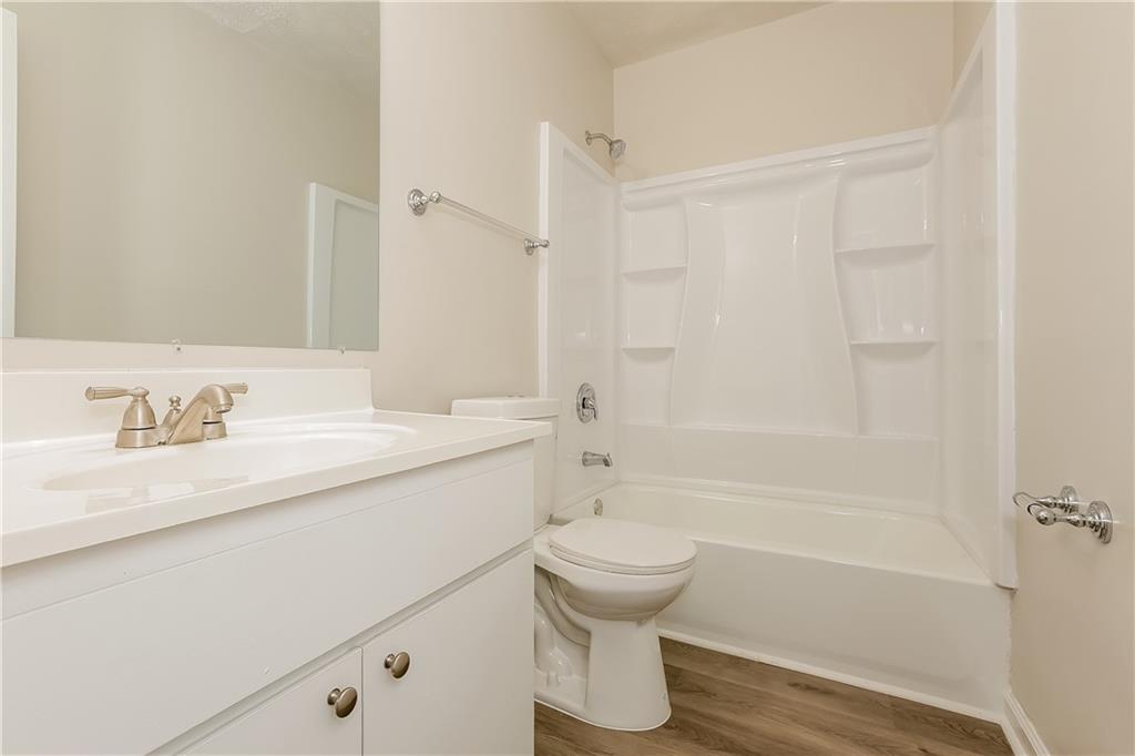 3352 Herrenhut Road Lithonia, GA 30038 - Photo 14 of 27 a bathroom with a granite countertop sink toilet and shower