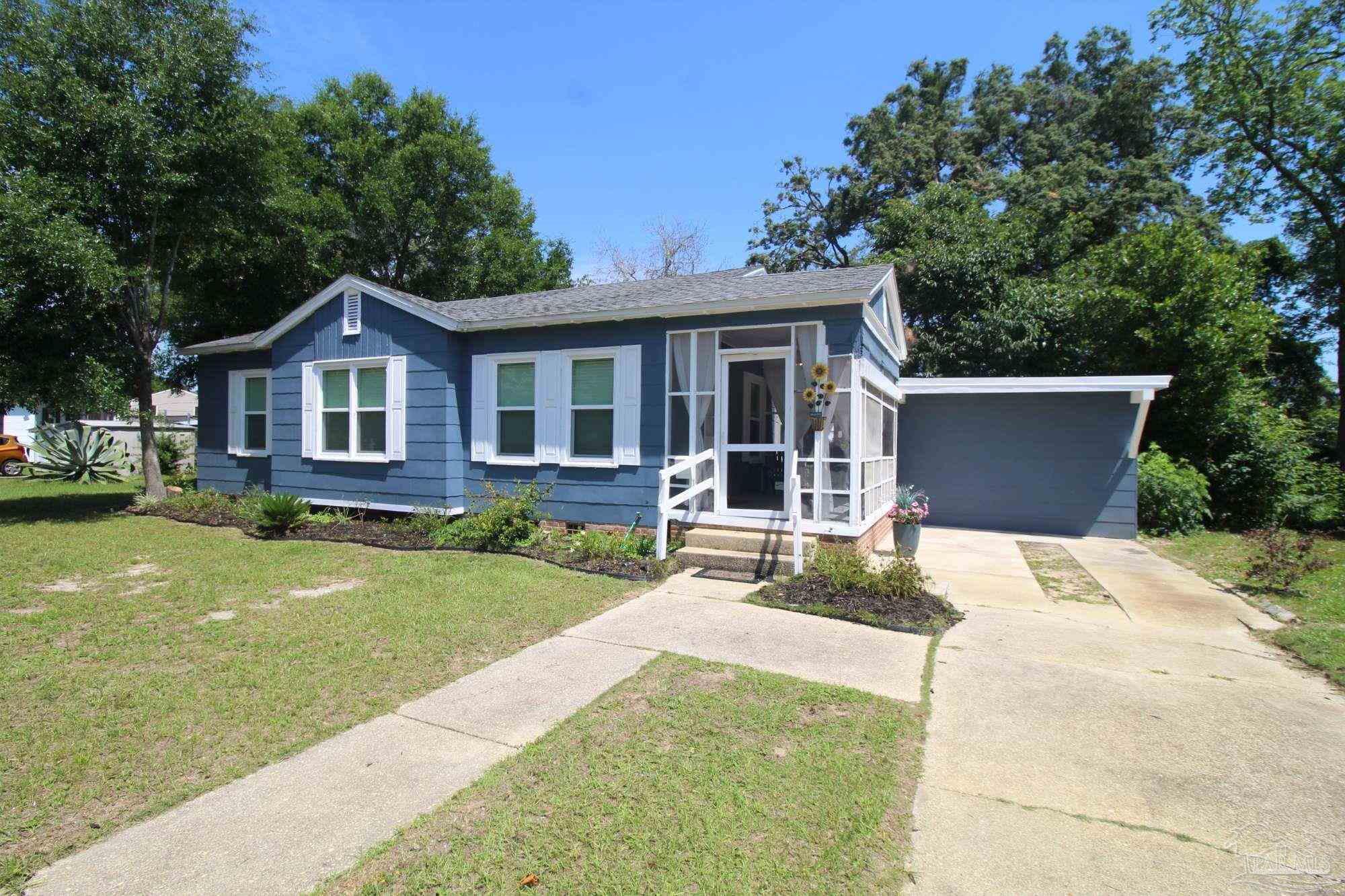 315 Flannan Road Pensacola, FL 32507 - Photo 2 of 17 a front view of a house with a yard and trees