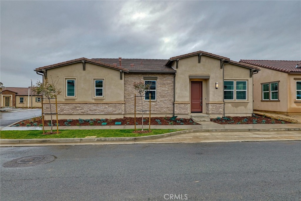 24510 Via La Valencia, CA 91354 - Photo 16 of 25 a front view of a house with a yard and garage