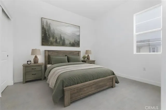 a bedroom with a bed and a window