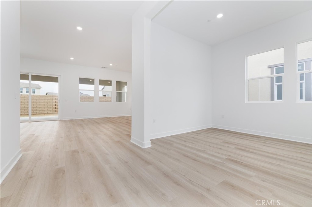 24510 Via La Valencia, CA 91354 - Photo 3 of 25 an empty room with wooden floor and windows