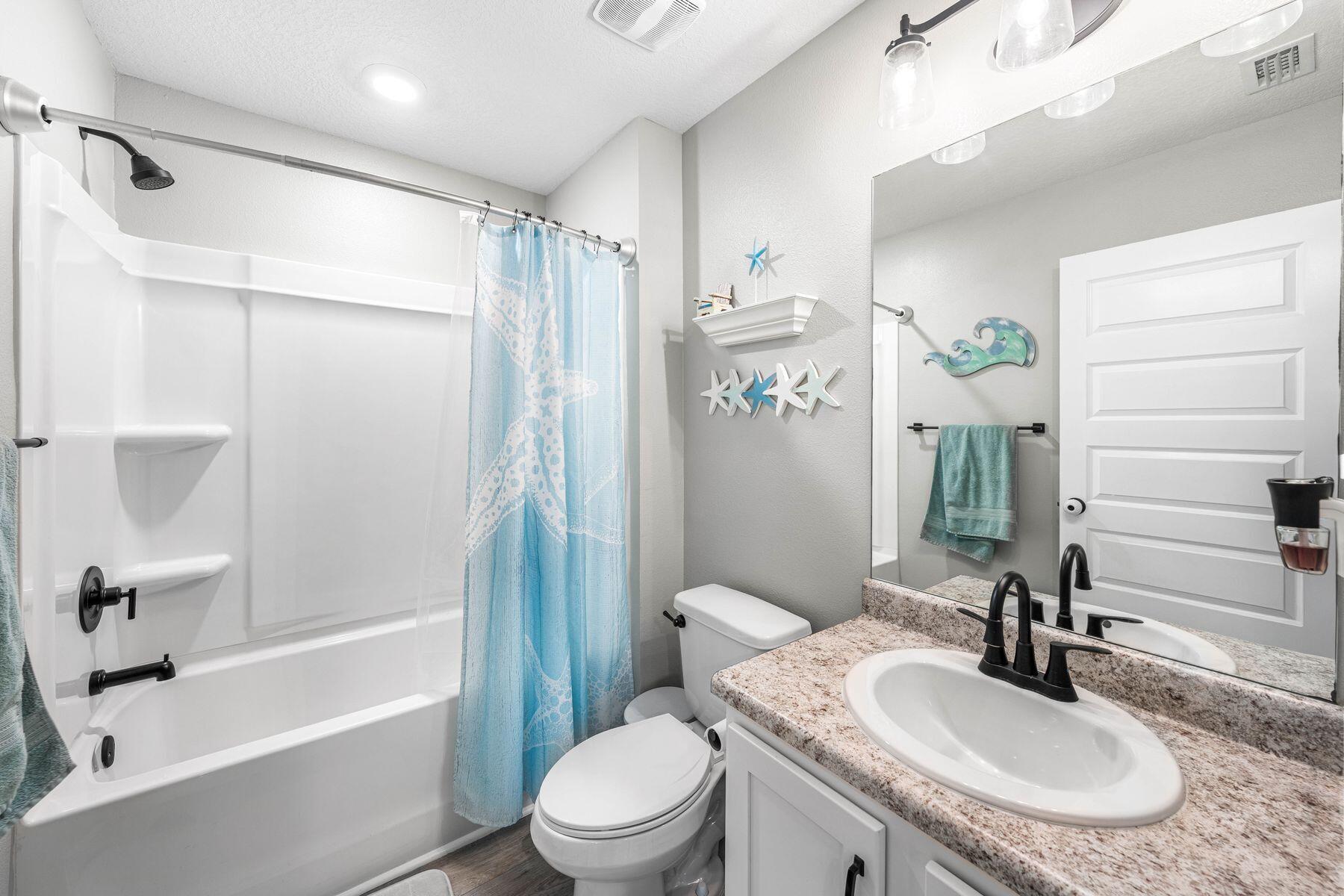 396 This Way Freeport, FL 32439 - Photo 11 of 30 a bathroom with a sink toilet and shower