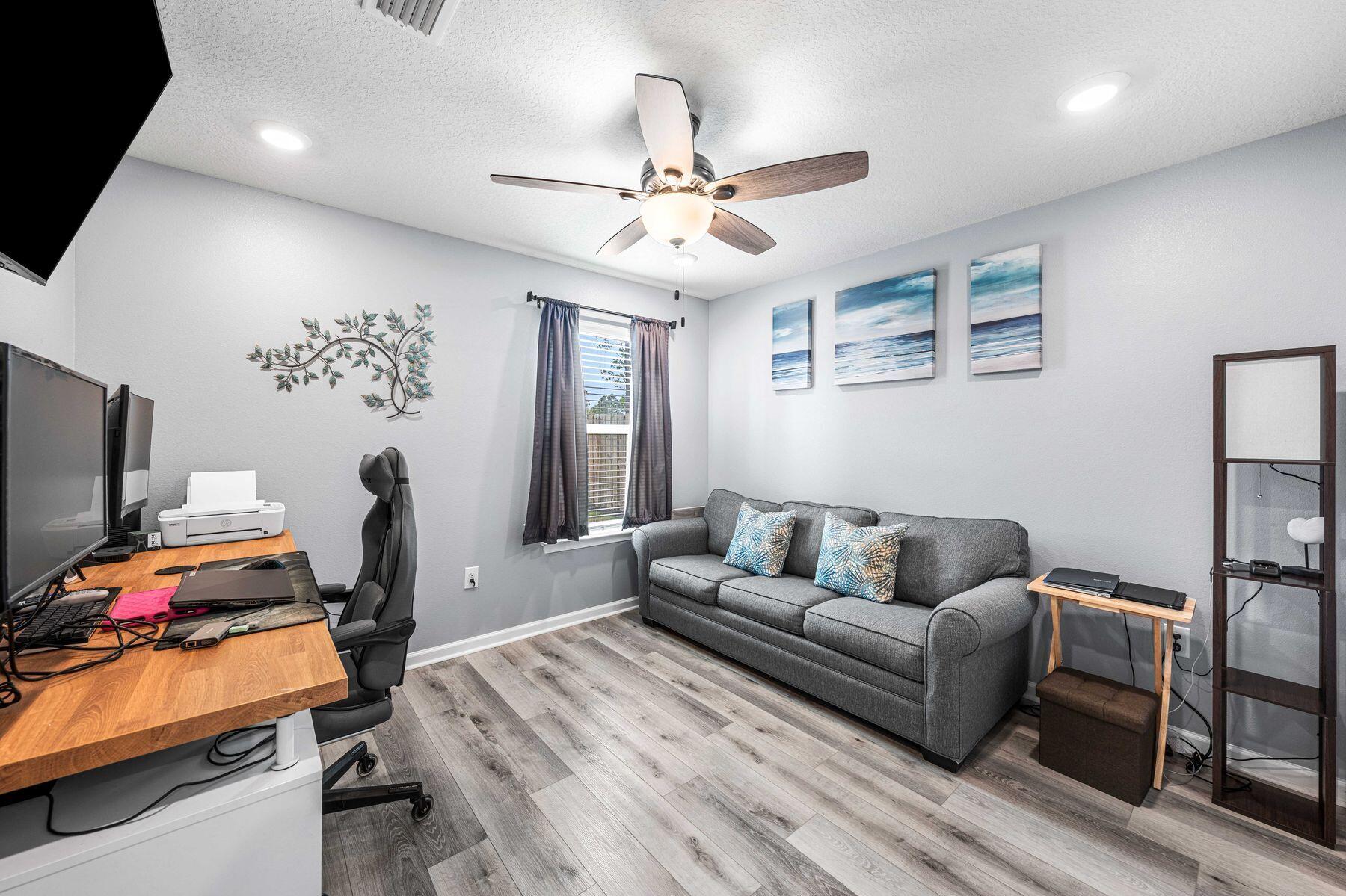 396 This Way Freeport, FL 32439 - Photo 12 of 30 a living room with furniture and a flat screen tv