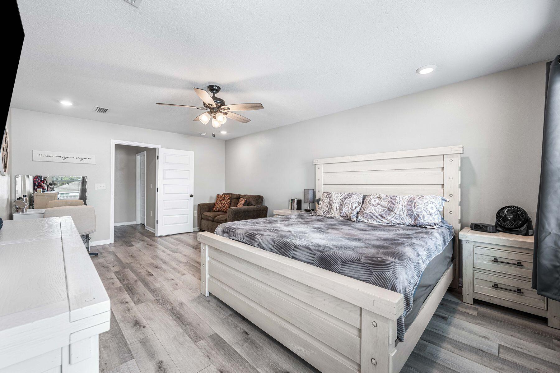 396 This Way Freeport, FL 32439 - Photo 13 of 30 a bedroom with bed and a chandelier