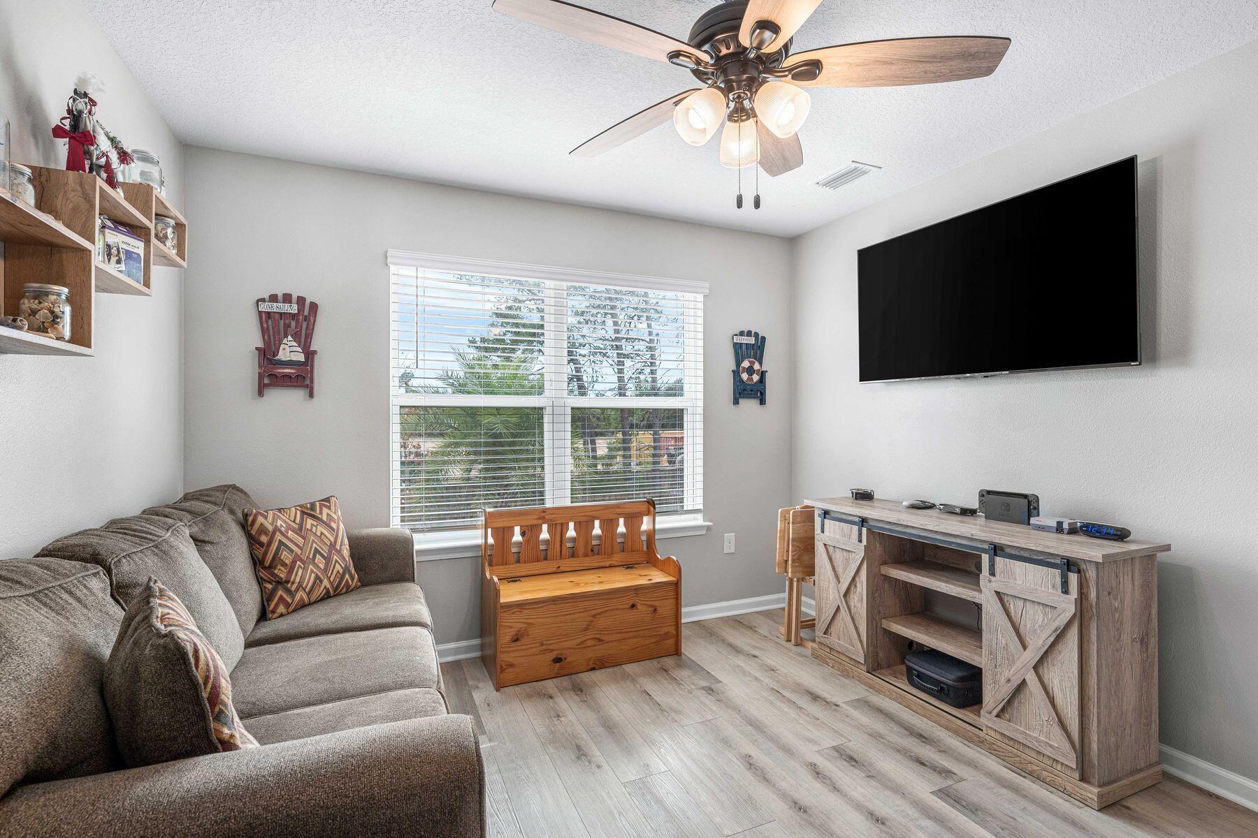 396 This Way Freeport, FL 32439 - Photo 17 of 30 a living room with furniture and a flat screen tv