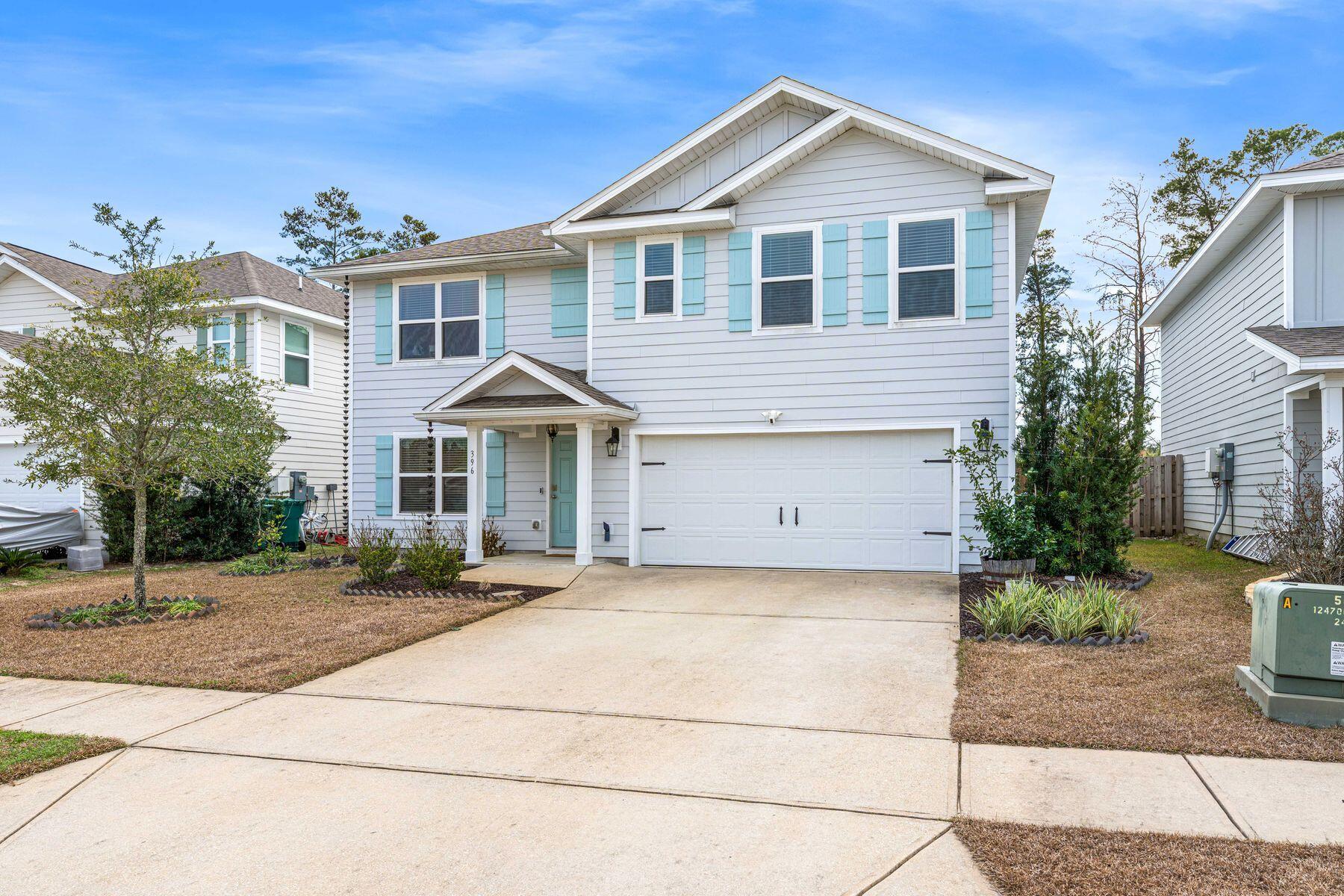 396 This Way Freeport, FL 32439 - Photo 22 of 30 a front view of a house with a yard and garage