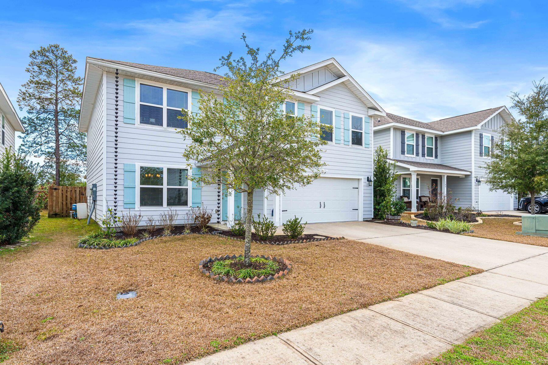 396 This Way Freeport, FL 32439 - Photo 23 of 30 a front view of a house with garden