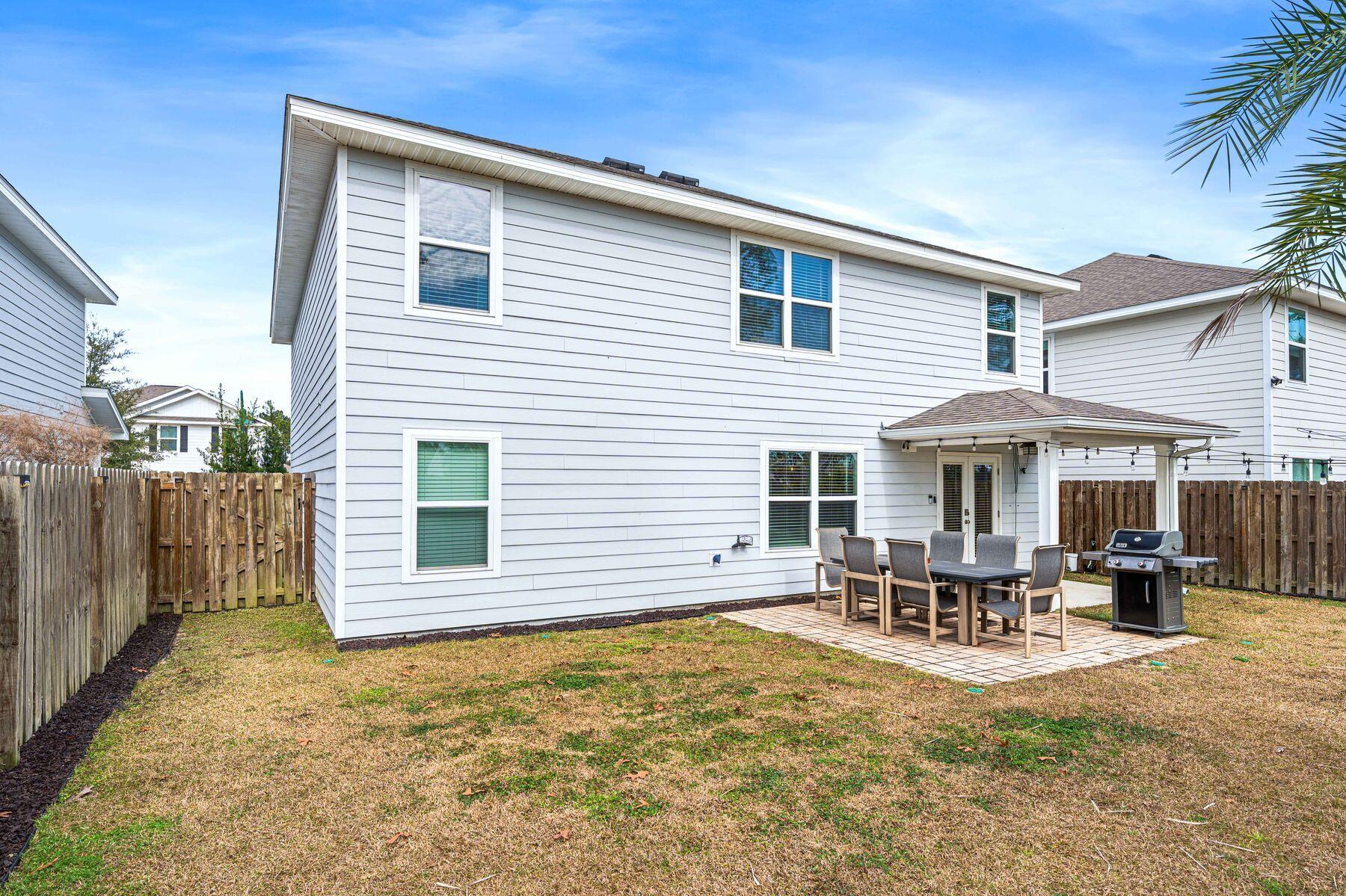 396 This Way Freeport, FL 32439 - Photo 26 of 30 a backyard of a house with table and chairs