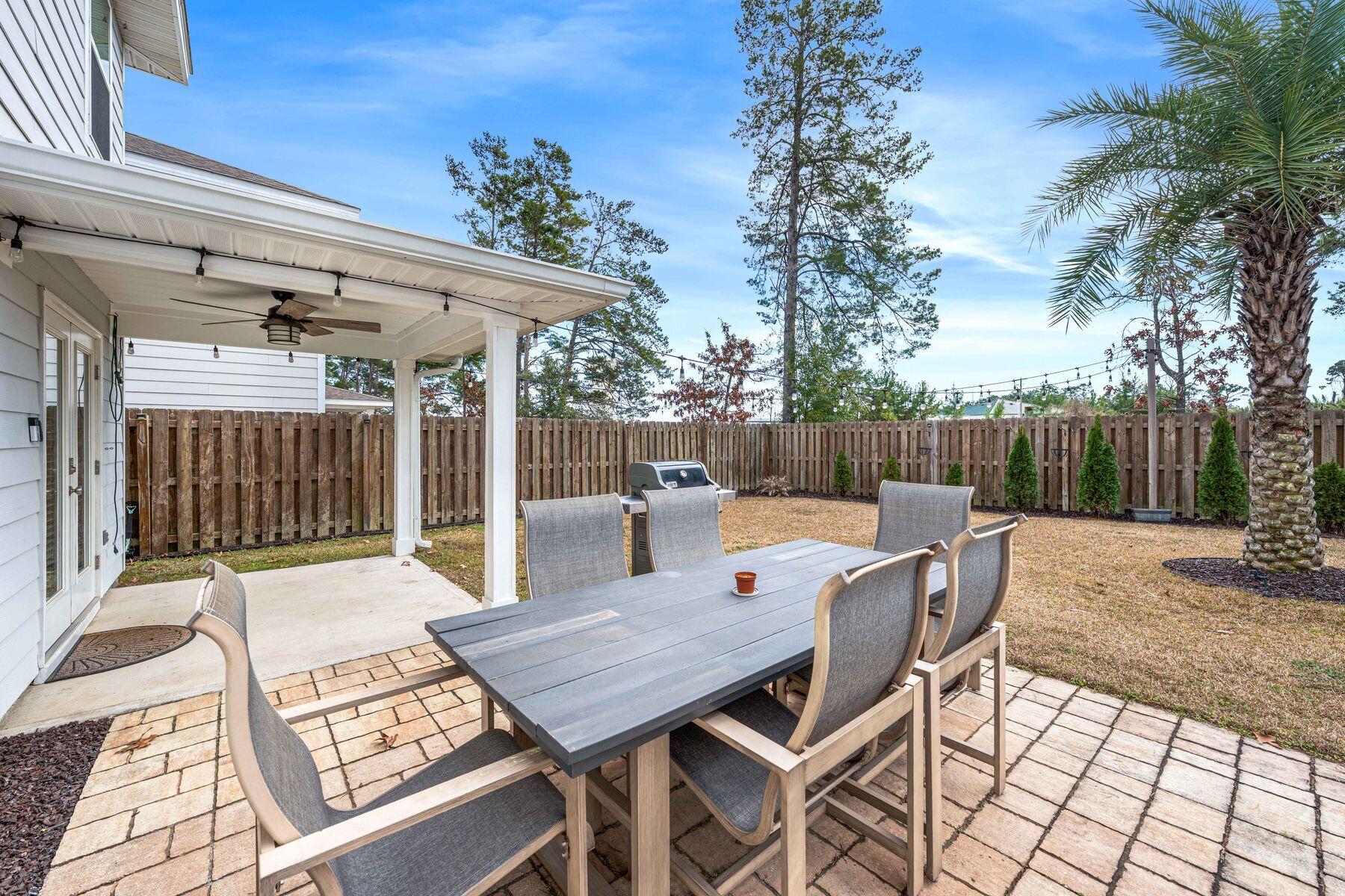396 This Way Freeport, FL 32439 - Photo 3 of 30 a view of a patio with table and chairs with wooden floor and fence