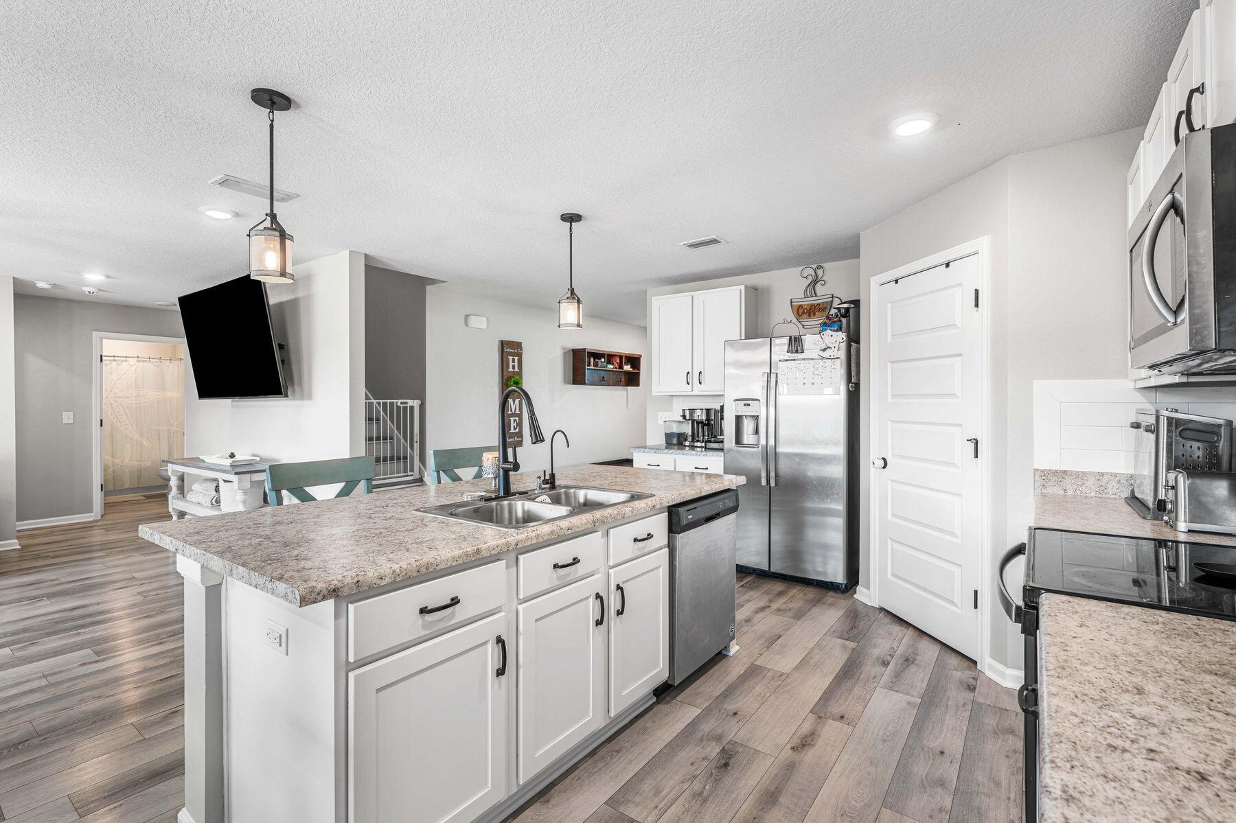 396 This Way Freeport, FL 32439 - Photo 7 of 30 a kitchen with a sink stove and refrigerator