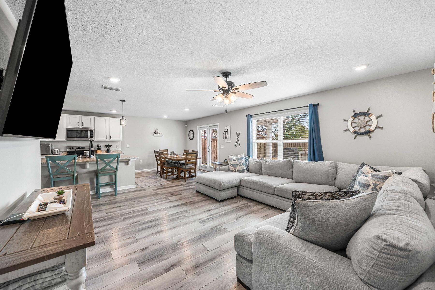 396 This Way Freeport, FL 32439 - Photo 10 of 30 a living room with furniture kitchen and a flat screen tv
