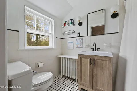 a view of a chairs and table in backyard of the house