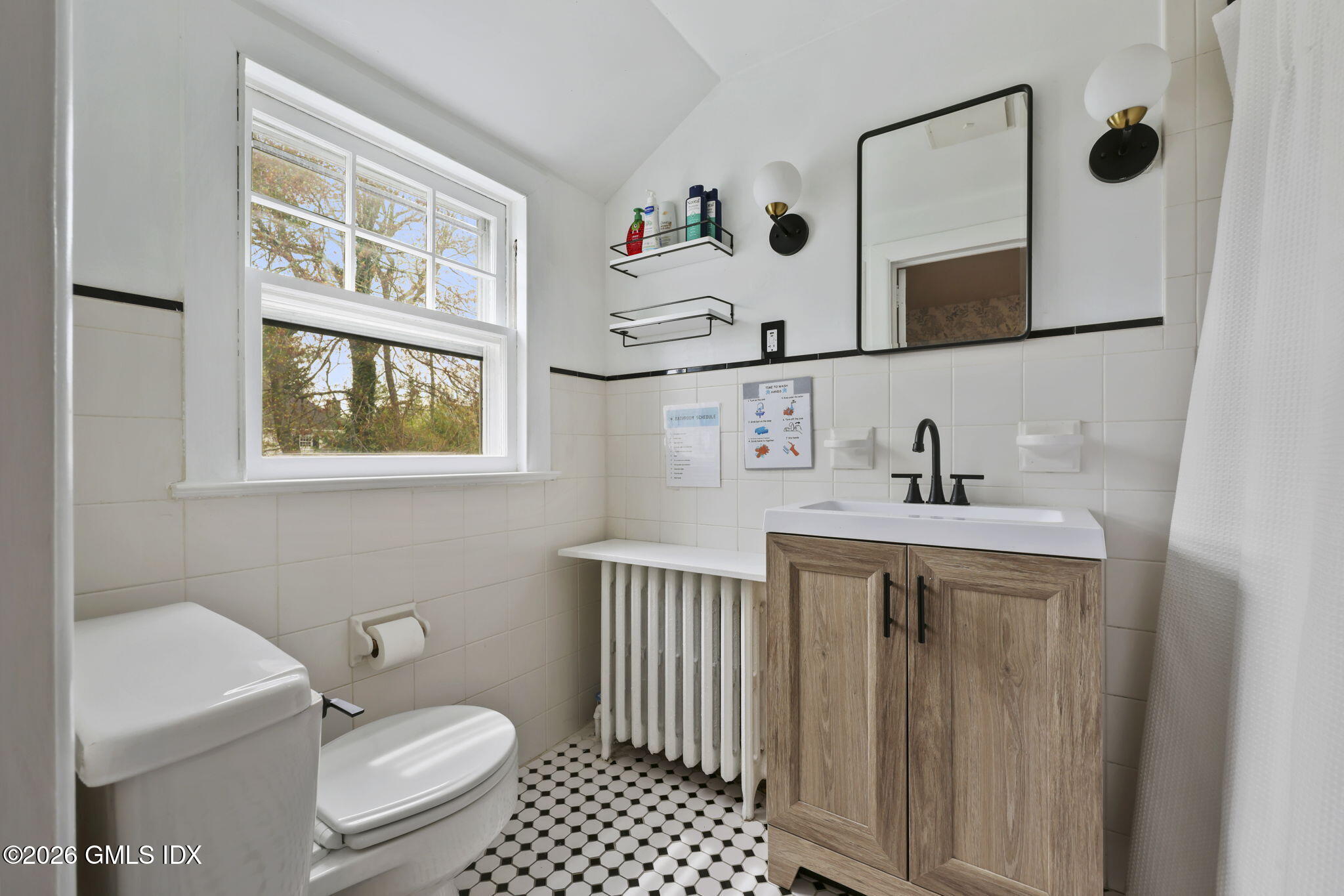 64 Summit Road Riverside, CT 06878 - Photo 18 of 34 a bathroom with a sink a toilet and mirror