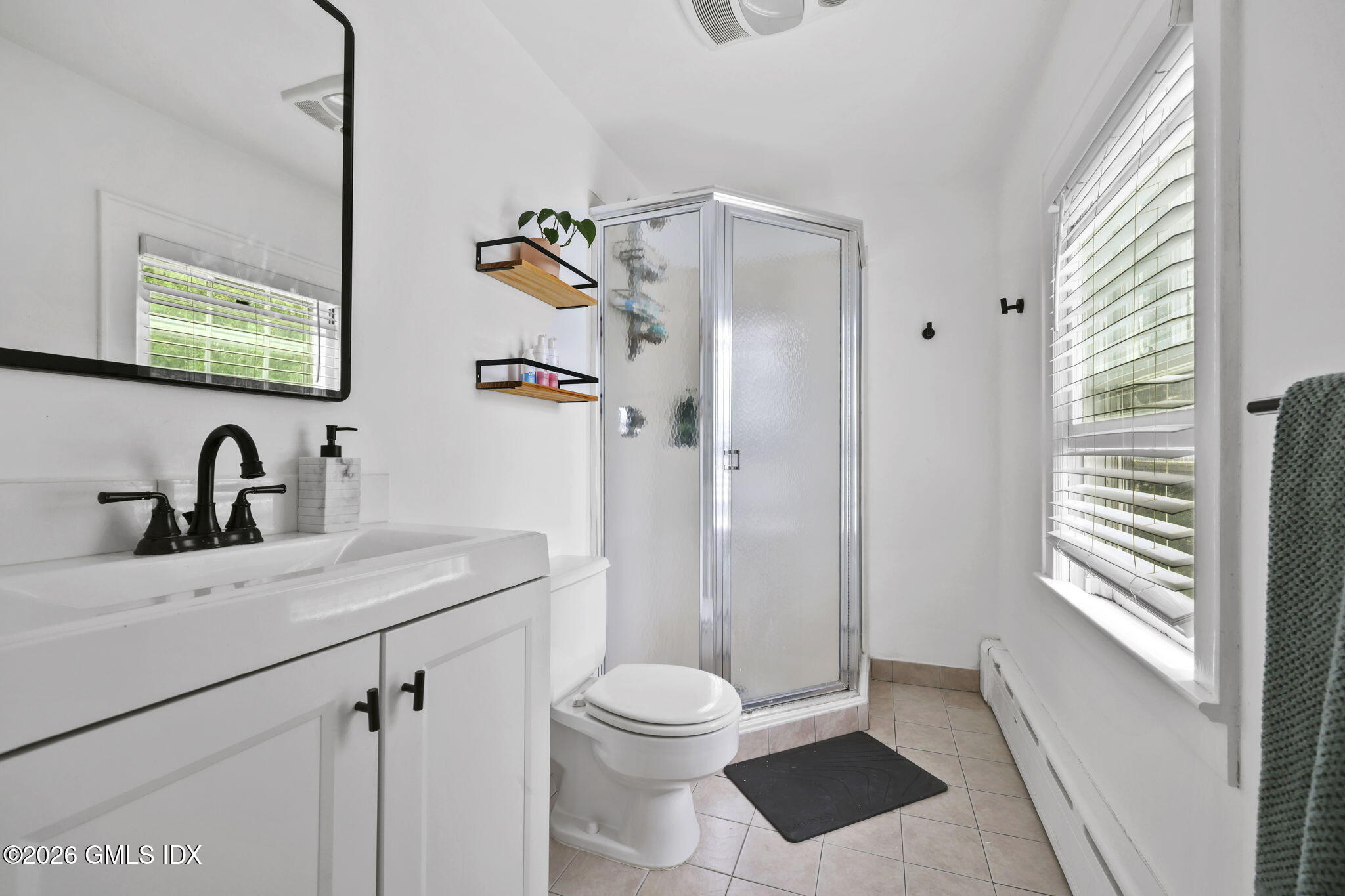 64 Summit Road Riverside, CT 06878 - Photo 20 of 34 a bathroom with a sink a toilet and shower