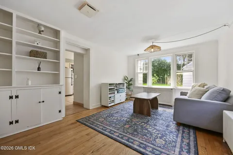 a view of a kitchen with kitchen island granite countertop a sink and a stove