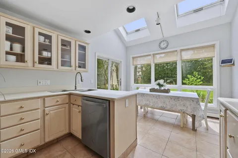 a bathroom with a granite countertop sink a toilet and shower