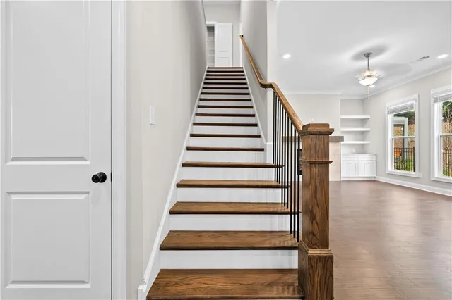 a view of entryway and hall with wooden floor