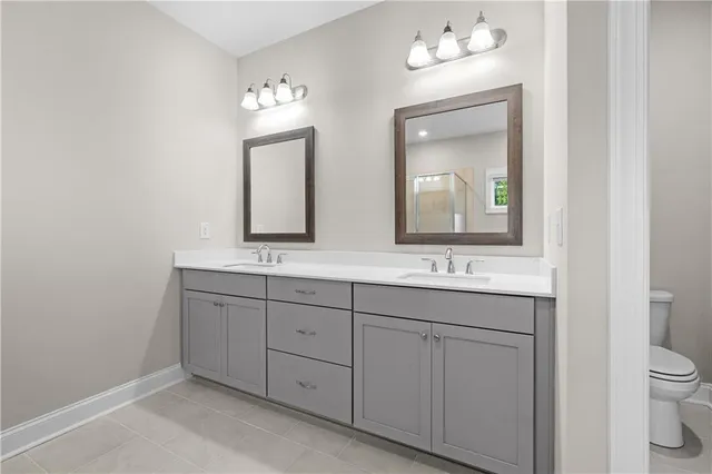 a bathroom with a double vanity sink and a mirror