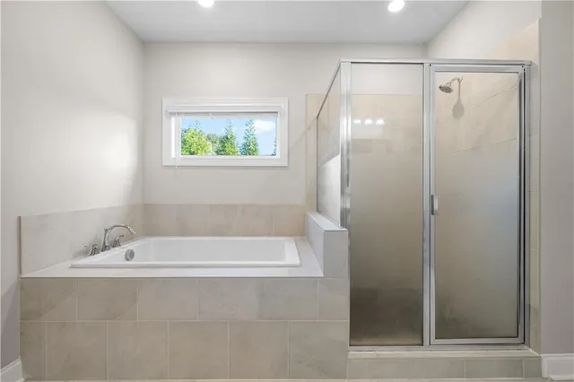 a bathroom with a bathtub and a shower