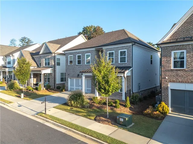 a front view of house with yard outdoor seating and barbeque oven
