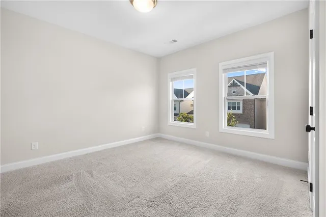 an empty room with windows and closet