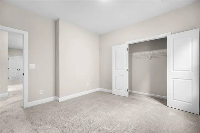 an empty room with closet area