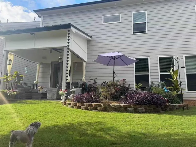 a front view of house with yard and outdoor seating