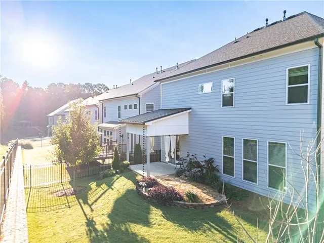 a view of a house with pool and sitting area