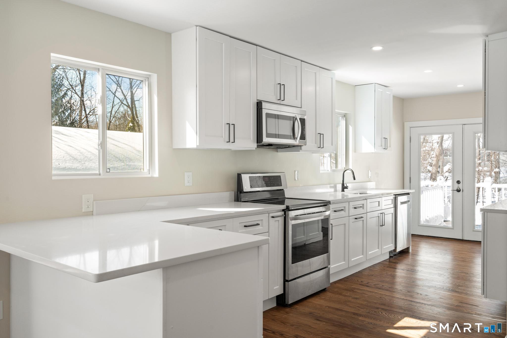 6 Juniper Ridge Drive Danbury, CT 06811 - Photo 12 of 36 a kitchen with stainless steel appliances white cabinets a sink a stove a refrigerator and microwave