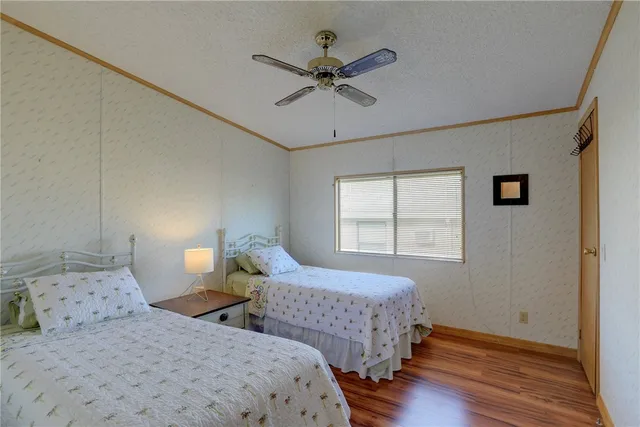 a bedroom with two beds and a window