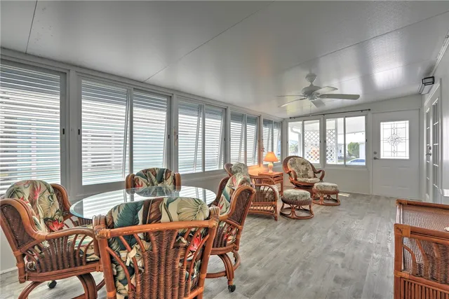 a living room with furniture and large windows