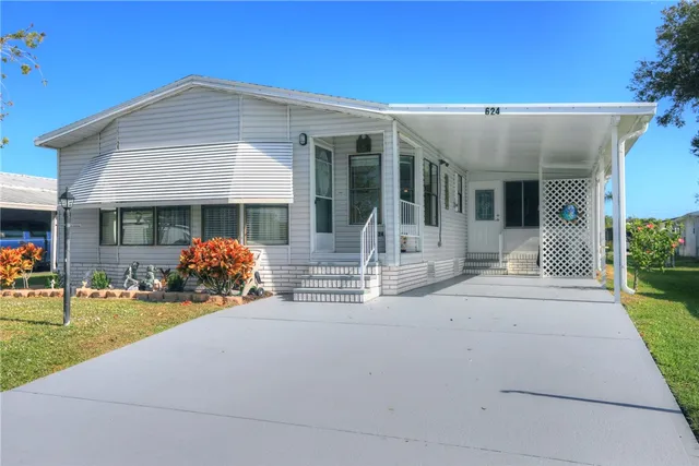 a front view of a house with garden and patio
