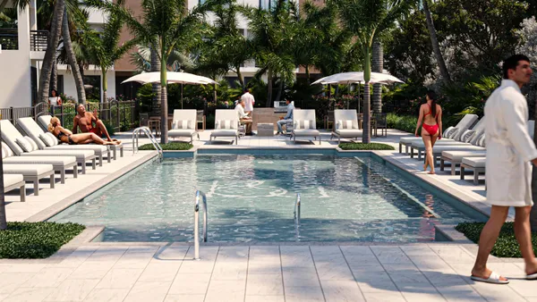 a view of a patio with chairs and umbrellas on a patio