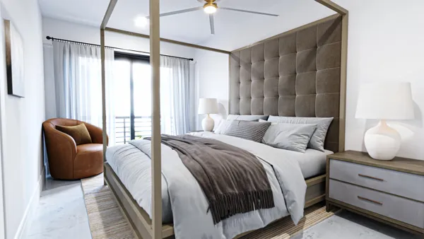 a bedroom with bed couch and window