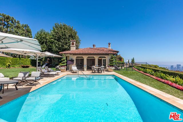 a view of a house with swimming pool and sitting area