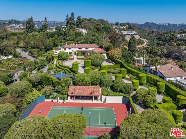 an aerial view of a house with yard swimming pool and mountain view