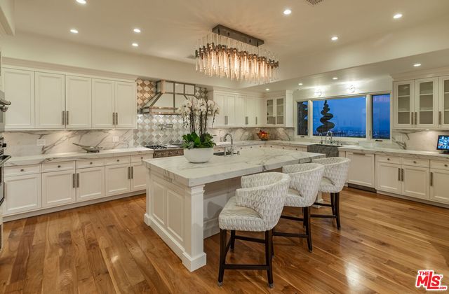 a kitchen with stainless steel appliances granite countertop a sink and cabinets