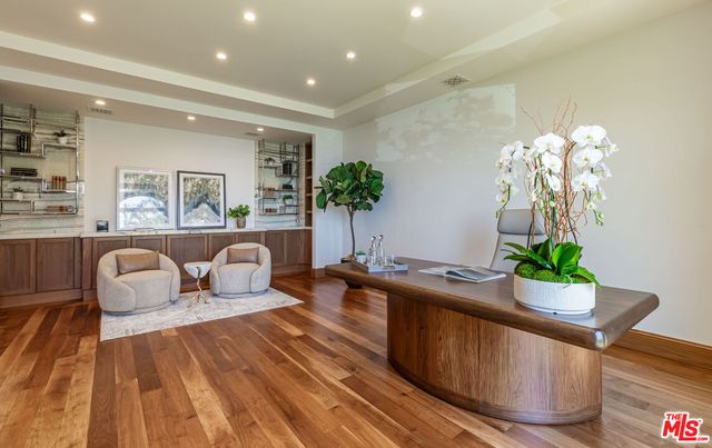 a bathroom with a sink mirror and a shower
