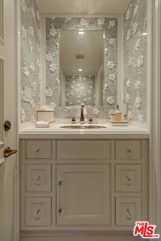 a view of a house with patio a fire pit and chairs