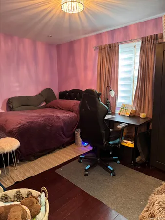a bedroom with furniture and a wooden floor
