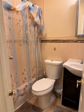 a white toilet sitting next to a bathroom sink